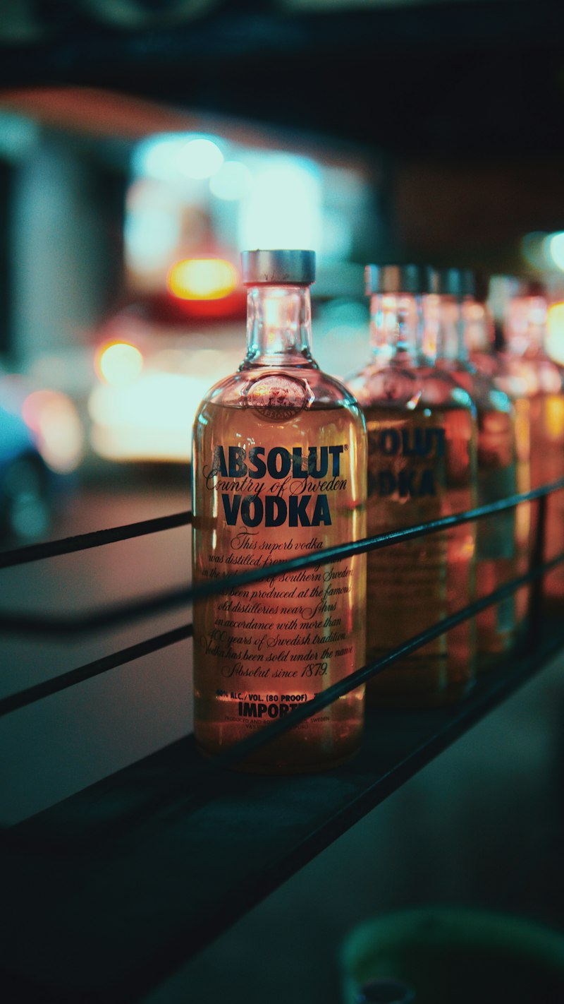 Real photograph of Absolut Vodka bottles on lighted shelf