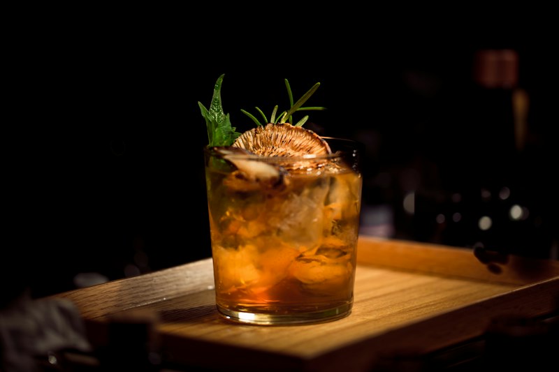 Real photograph of craft cocktail served in crystal glass with garnish